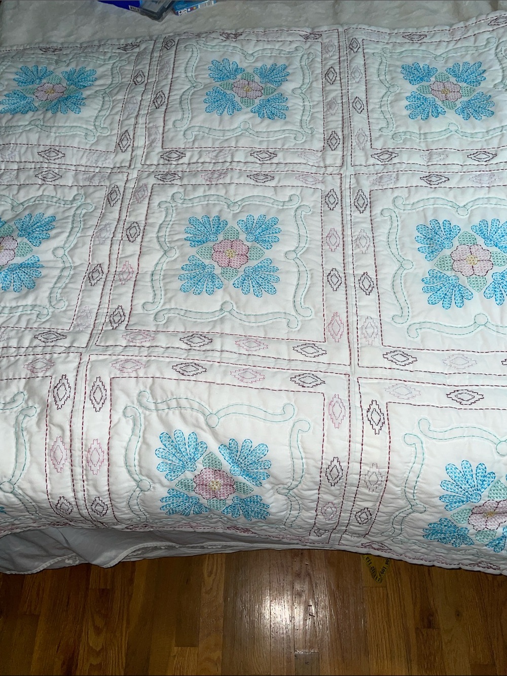Lightweight white quilt with cross stitched floral squares-50” x 50”